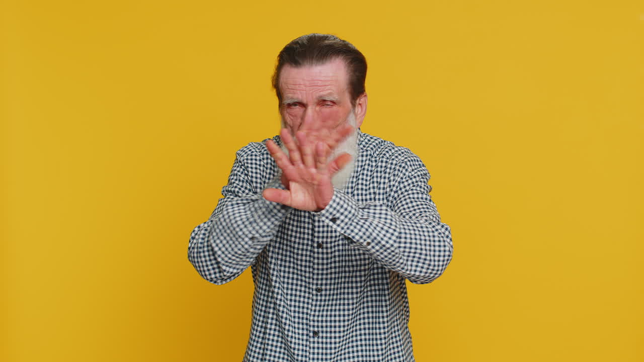 Afraid shocked senior old man closing eyes confused shy scared reject to watch phobia shame stress