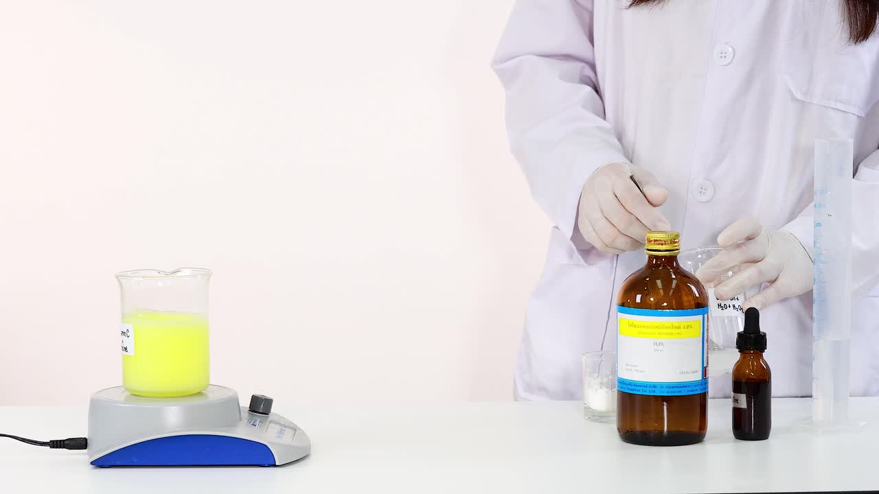 Scientist demonstrates iodine clock reaction chemistry experiment in laboratory setting