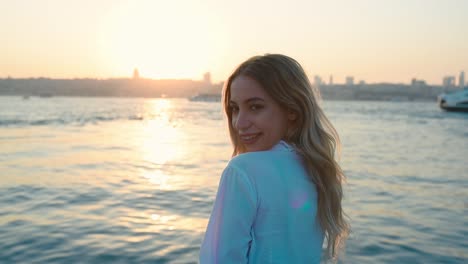 Slow-Motion:Beautiful-girl-enjoys-sunset-view-of-bosphorus-and-Istanbul,-a-popular-destination-in-Istanbul,-Turkey