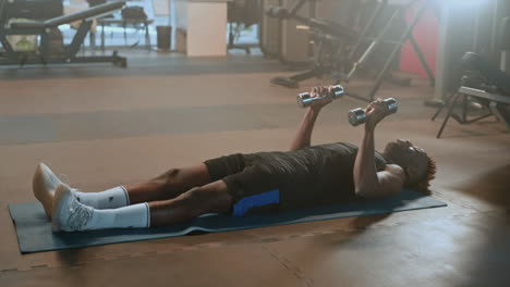 man doing dumbbell chest exercise