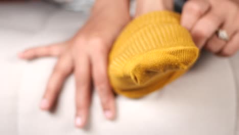 closeup of a yellow ribbed sock on a sofa