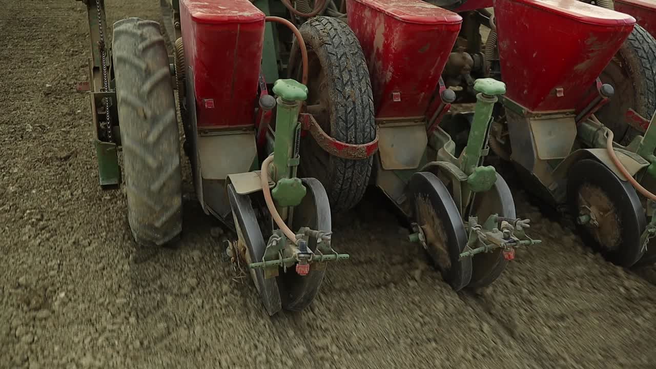 Close up of Tractor Operated Automatic hydraulic Seed Planter Drill in agricultural organic natural biologic soil, modern farming