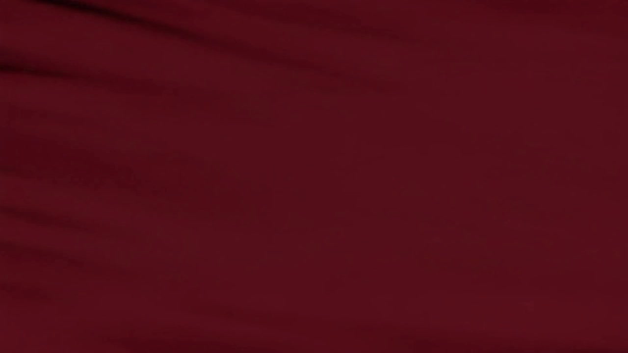 Tessuto astratto rosso scuro che ondeggia al vento