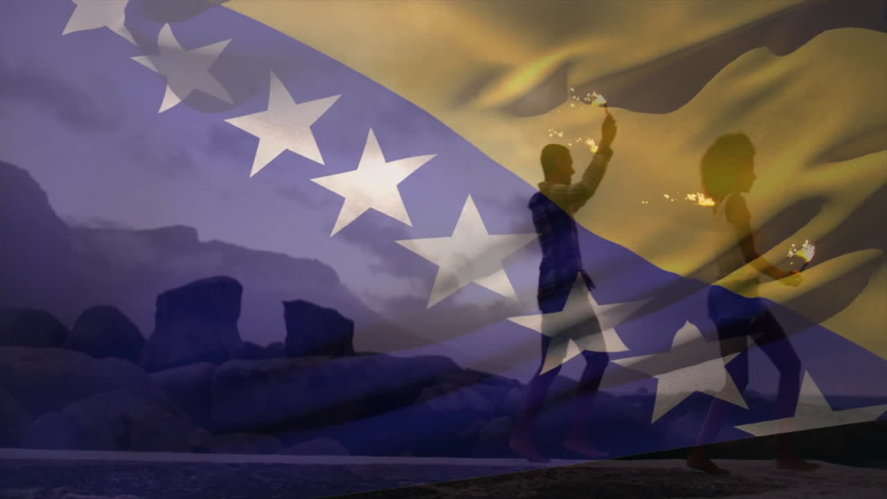 Performing fire dance, people with Bosnia and Herzegovina flag in rocky landscape