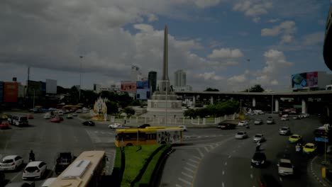 watching the cars at the victory monument in bangkok