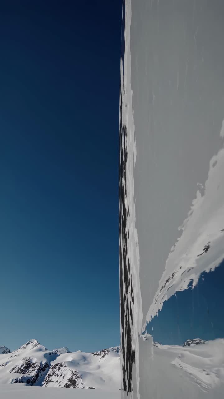 Abstract video concept with a distorted reflection of snowy mountains
