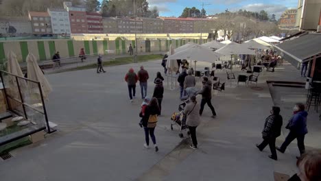 group of locals coming down stairs onto street in ordes in spain. pan right