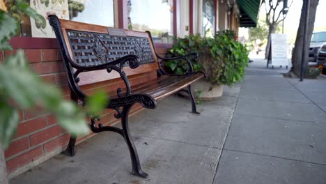 empty wooden and metal bench in downtown