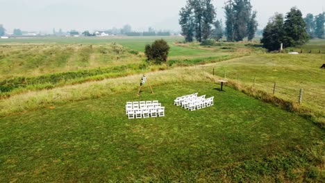 drone footage of ceremony on green grass field
