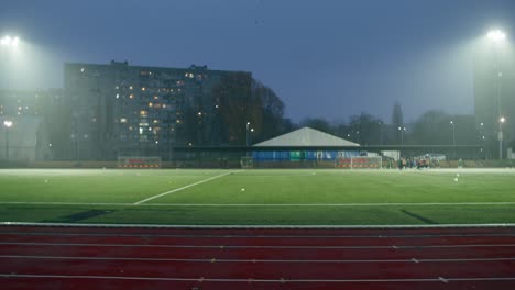 athlete training on track at night