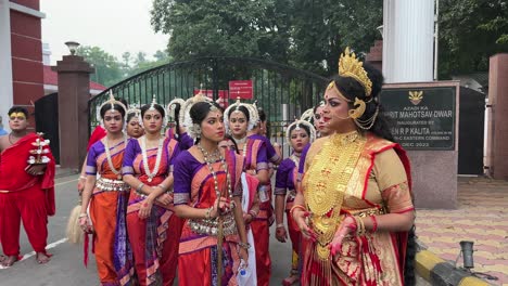 pan view capturing women and girls before rehearsals at red road in kolkata, india. durga puja procession.