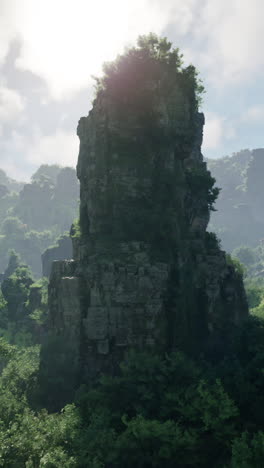 majestic tall rock formation in lush jungle