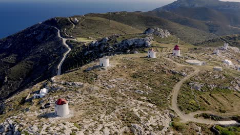 Ancient-windmills-on-the-hills-around-the-village-of-Chora,-Aerial-View