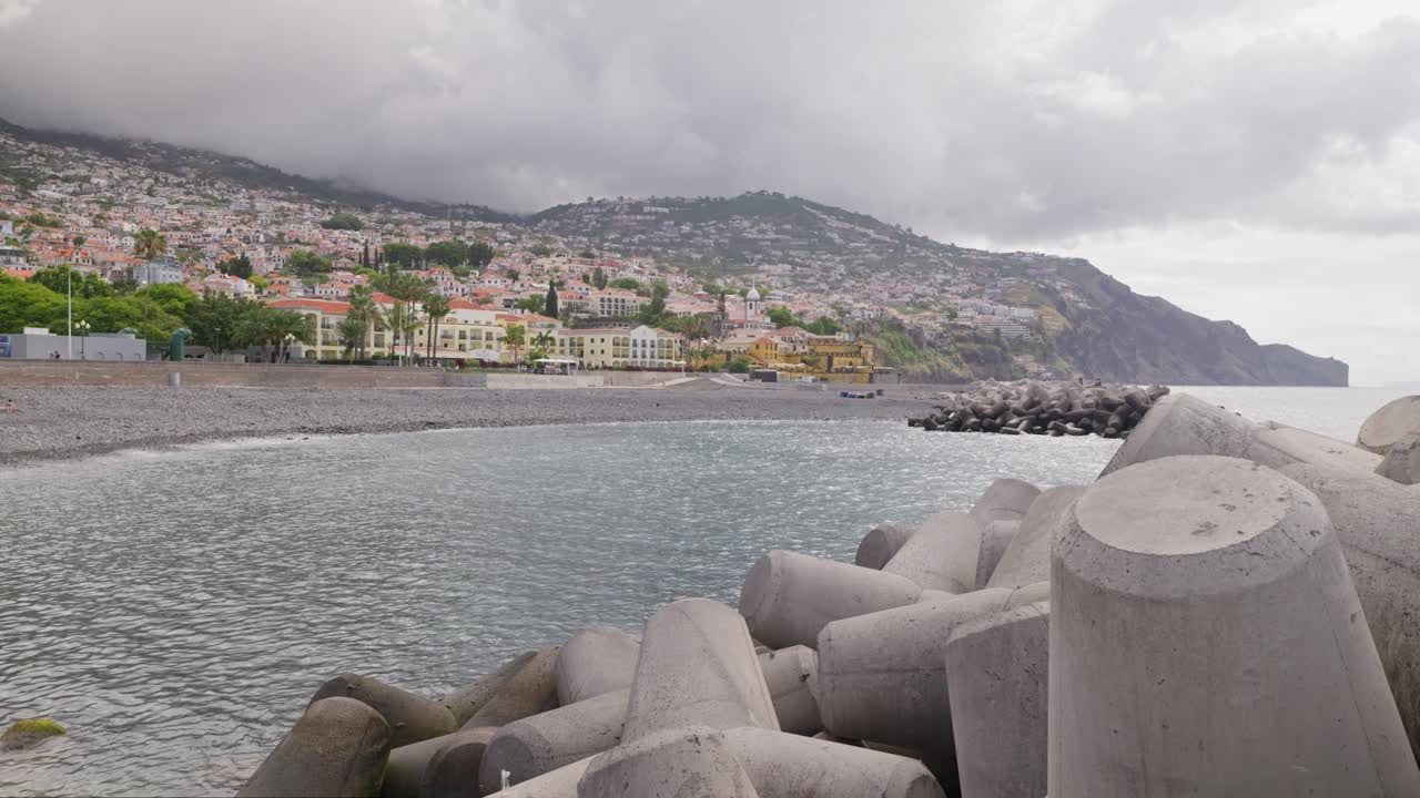 대서양 연안 근처의 파도 파괴자, 배경에는 마데라의 도시