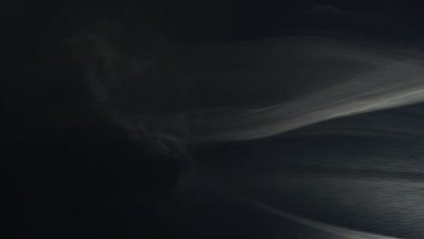 smoke from right to left. cloud of cold fog on black background.