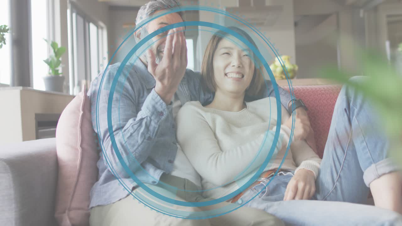 Mature man raising palm and initiating scanning animation around smiling partner showing AR feature