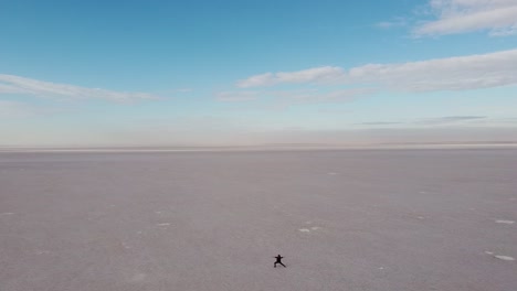 girl in a peaceful moment of yoga flow in the midle of a salt flat in turkey