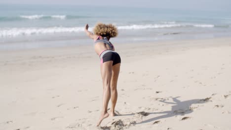 Young-Woman-Doing-Cartwheel-On-Beach