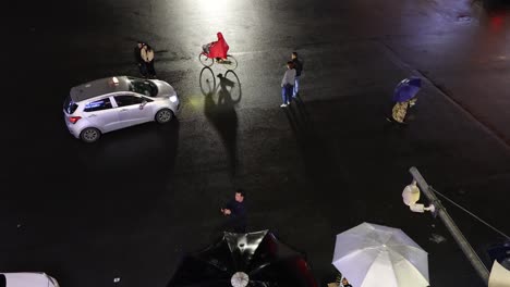 performers interact with vehicles at night.