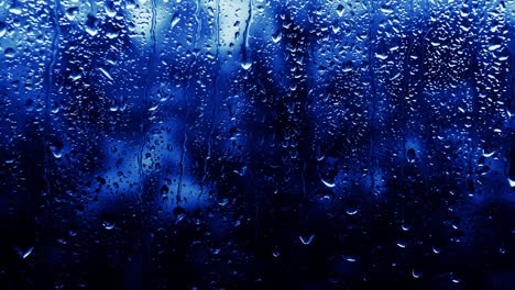 rainy background neon blue color, drops flow down the glass, copy space background