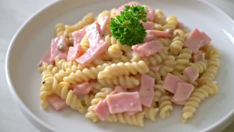 spirali or spiral pasta mushroom cream sauce with ham - italian food style