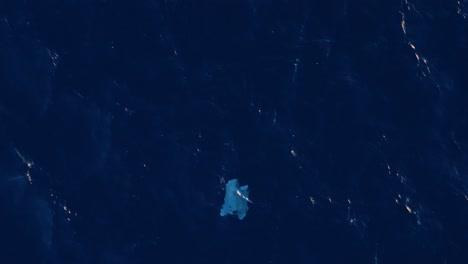 large white piece of marine debris plastic or flotsam drifts and distorts beneath ocean wave ripples