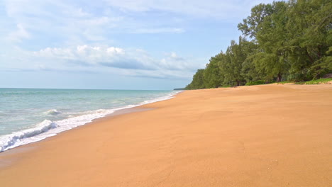 pan along the waves coming in on a beach in southeast asia