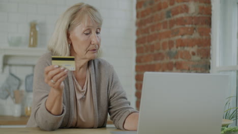 senior woman shopping online with credit card