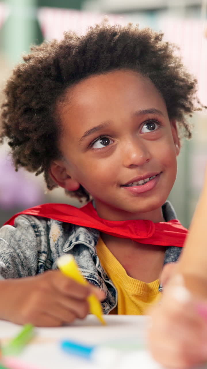 Boy drawing in superhero costume