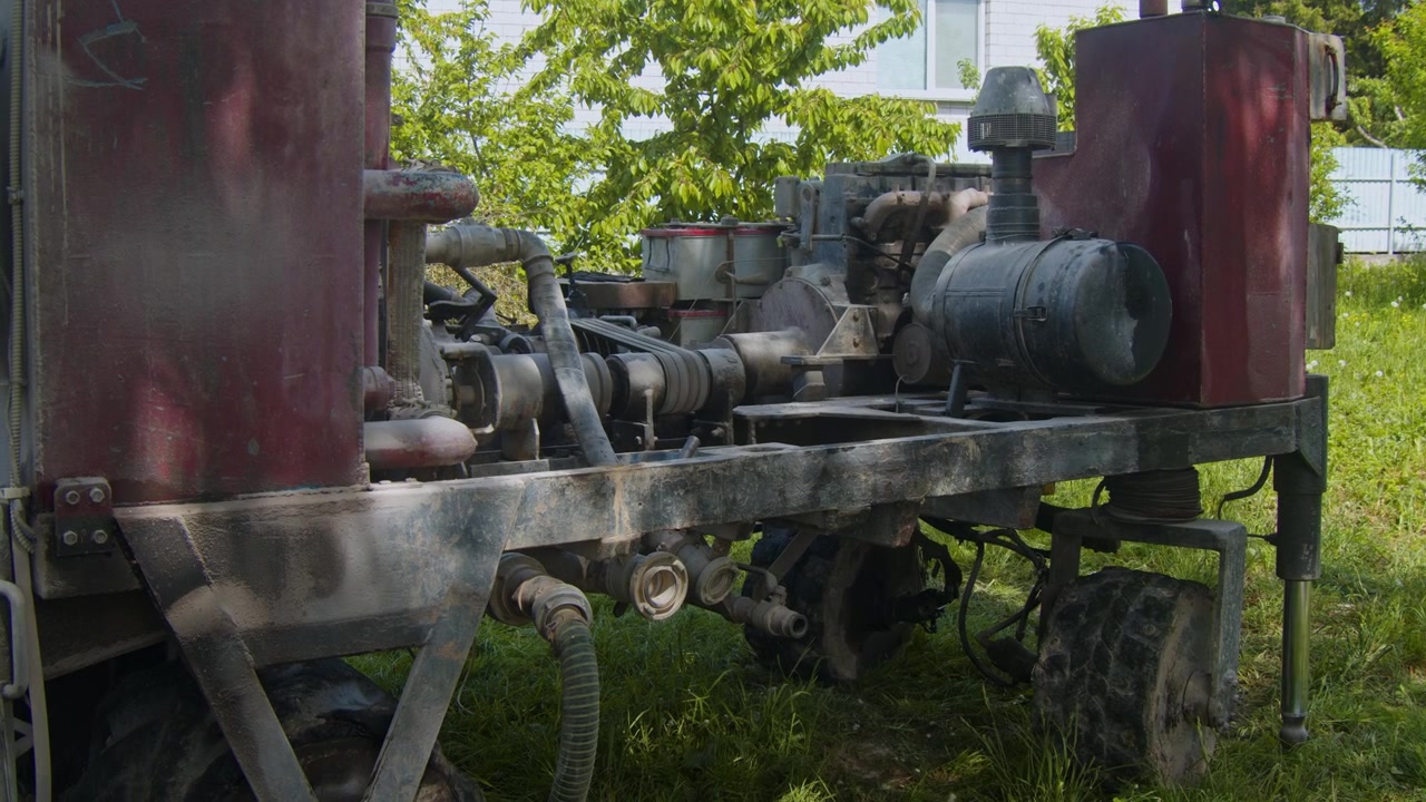Machine used for drilling water wells in open area near building