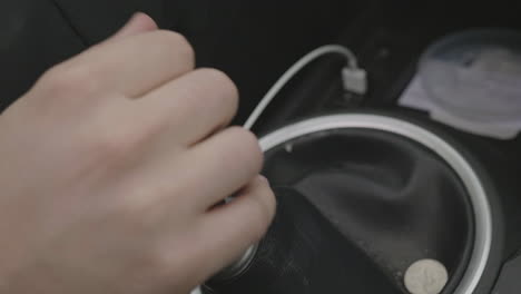 slow motion close up of a person shifting gears on a standard manual car