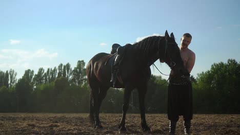 a man walks with a horse in the field 03