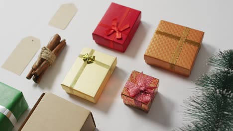 video of christmas decorations with presents and cinnamon sticks on white background