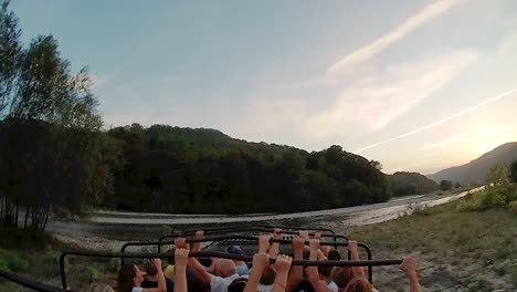 group adventure through scenic mountain river valley at sunset