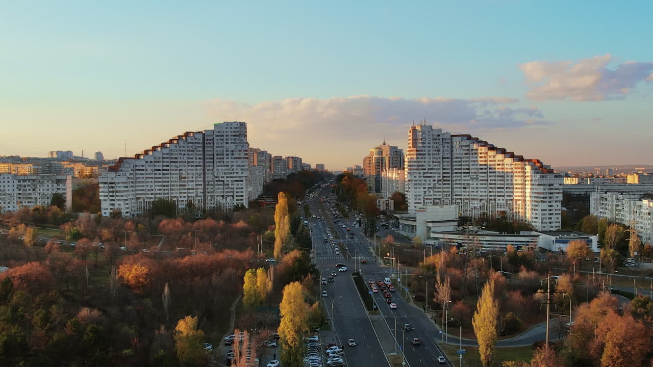 Aerial drone view of Chisinau at sunset, Moldova. View of the Сity Gates with multiple buildings and yellowed trees around