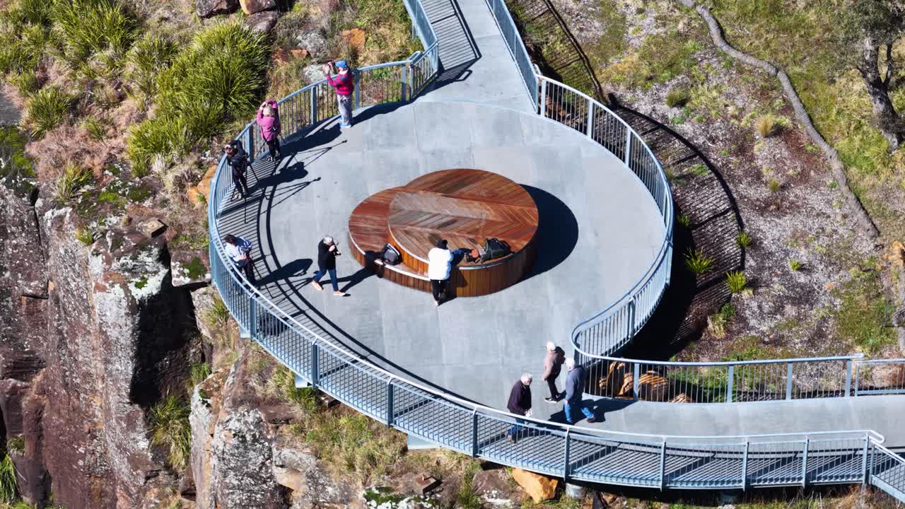 People enjoy views from a modern clifftop observation deck