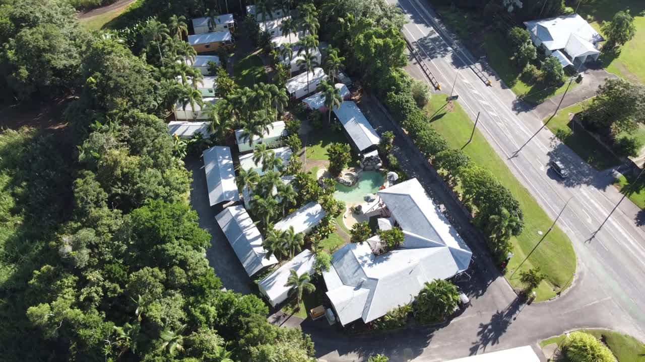 4K Aerial drone shot of tropical holiday resort with individual villas and a swimming pool in North Queensland, Australia