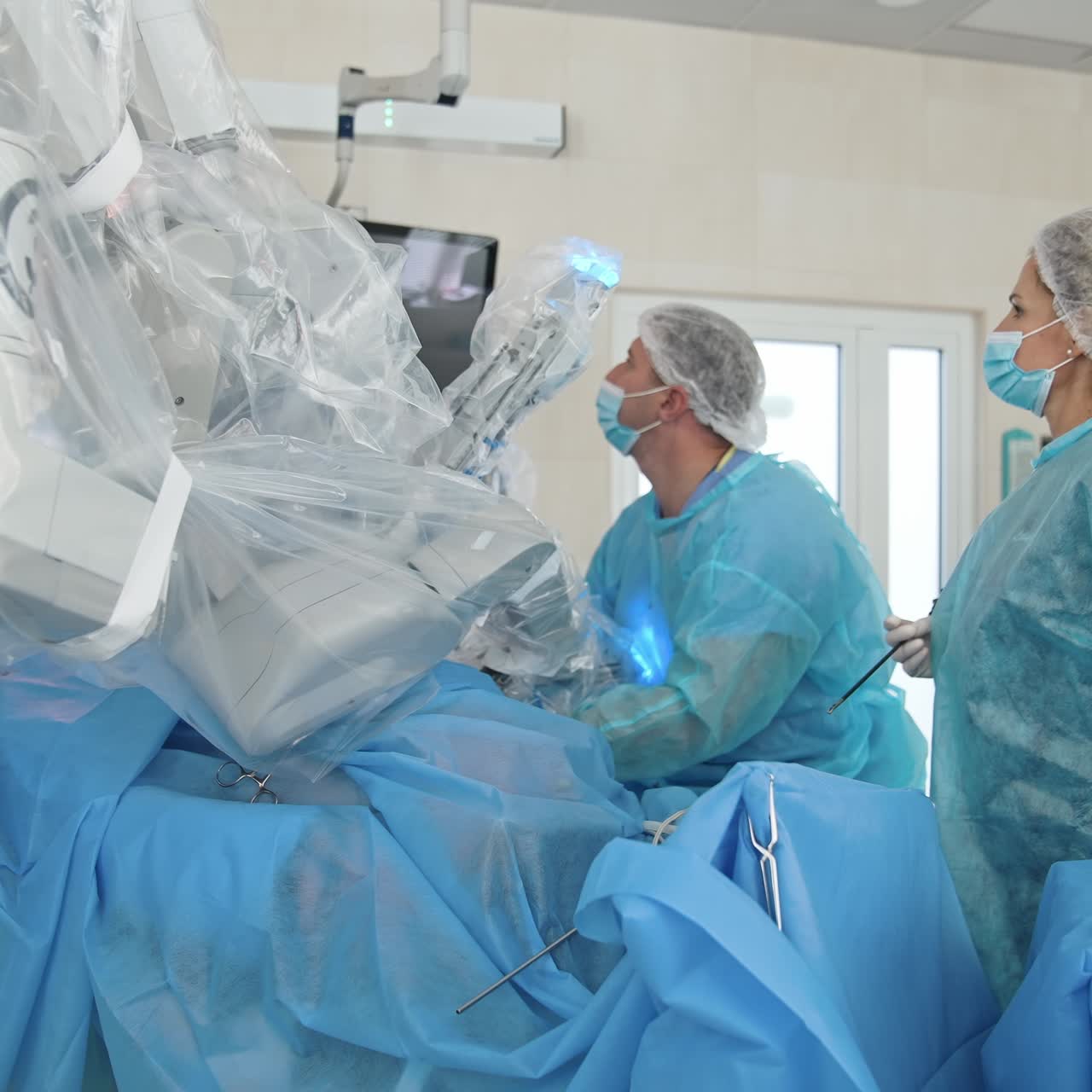Operating room with medical surgical robot. Doctors use surgical instruments. Medical robotic equipment during surgery. Minimally invasive robotic surgery