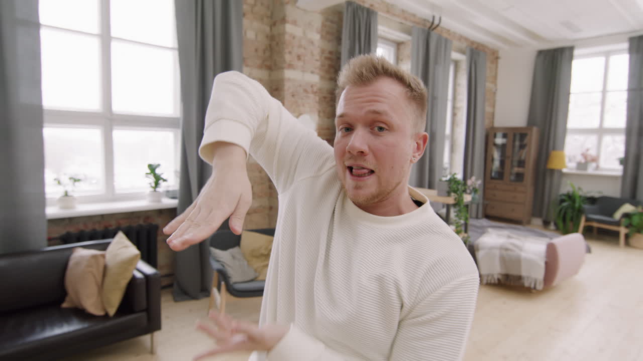 Happy Man Dancing and Posing in Loft Apartment