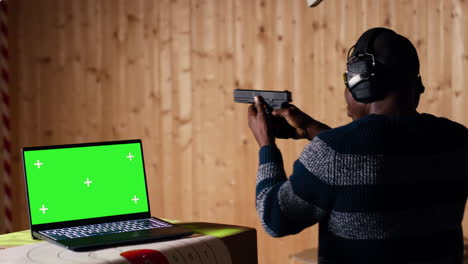 chroma key notebook and shooting range customer reloading pistol