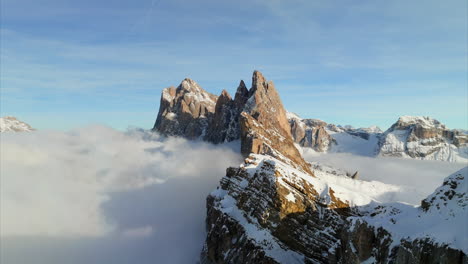 aerial drone pov of dolomites seceda odle mountain and val gardena peaks above sea of clouds