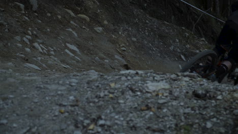 close up shot of a downhill racer riding down a steep passage in the trail on one wheel. downhill park in semmering austria. footage slowed down eight times