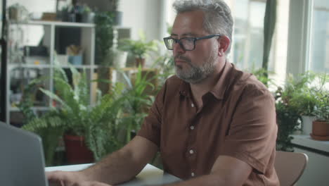 Mature Businessman Using Laptop in Office
