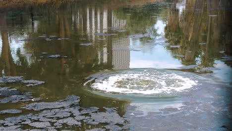 huge air bubbles burst on the surface of the lake in the oil field