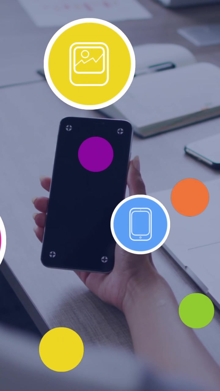 Animation of digital icons over rear view of a woman using smartphone with copy space at office