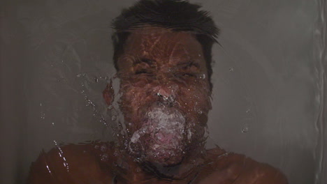 angry african american man screaming under water in a bath tub