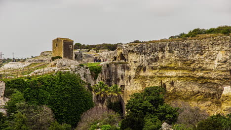 Static-view-of-Greek-theatre-at-Archaeological-Park-of-Neapolis,-Syracuse,-Sicily,-Italy-on-a-cloudy-day-in-timelapse