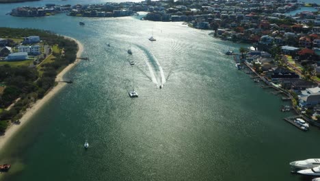 sovereign island and paradise point, sun glistening off canal, luxury homes and boats