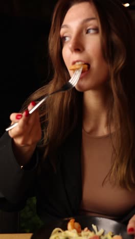 woman eating a piece of food with a fork