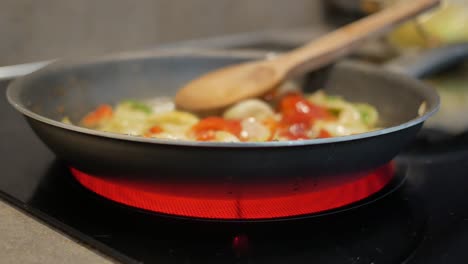 cooking vegetables in a pan on a stovetop